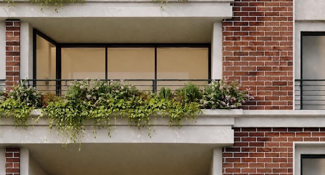 Close-up of a balcony, its planter spilling over the exposed brick